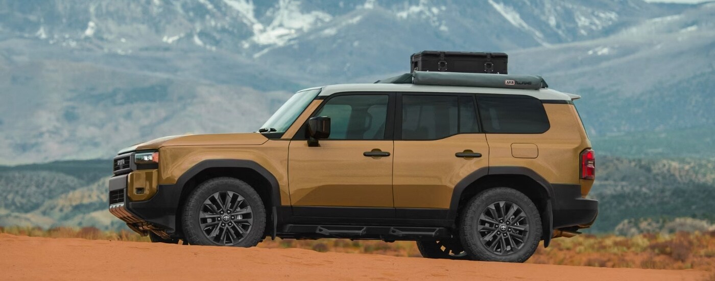 A tan 2025 Toyota Land Cruiser is shown from the side.