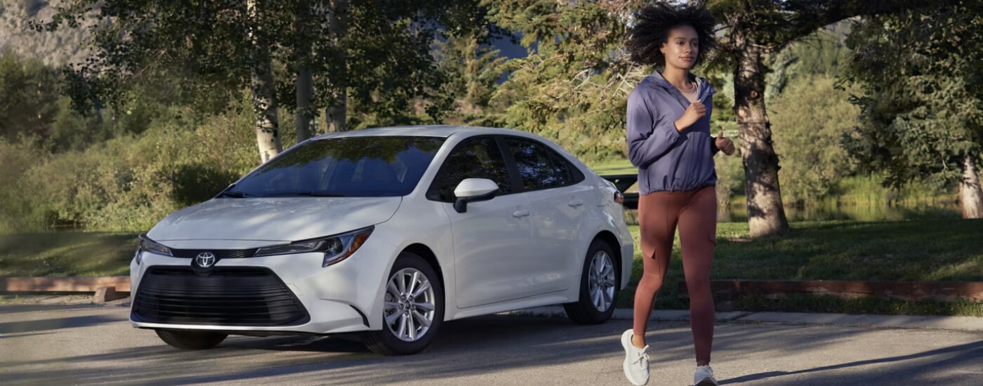 A white 2026 Toyota Corolla back into a spot