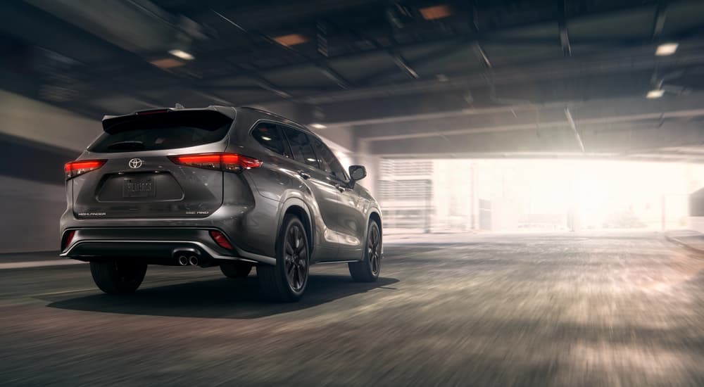 Grey 2025 Toyota Highlander XSE driving on a city street