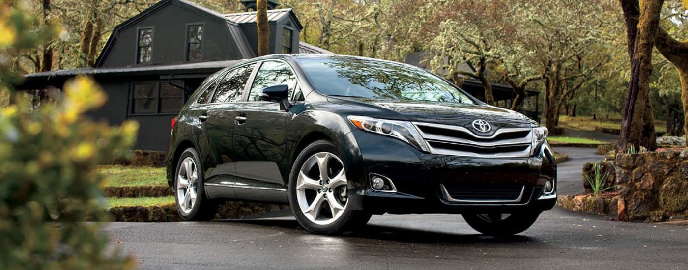 A black 2015 Toyota Venza is shown parked on a driveway.