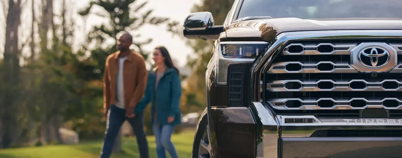 A close-up shows the passenger side headlight on a brown 2022 Toyota Tundra 1794 CrewMax.