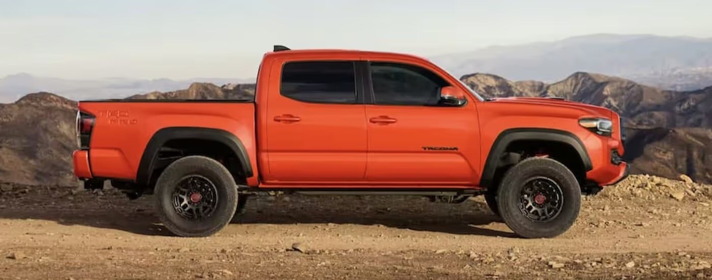 Orange 2023 Toyota Tacoma TRD Pro driving off-road