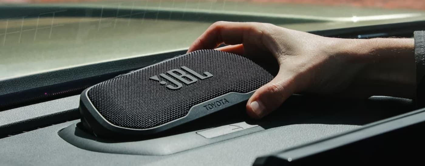 A JBL Flex portable speaker in a 2025 Toyota Tacoma.