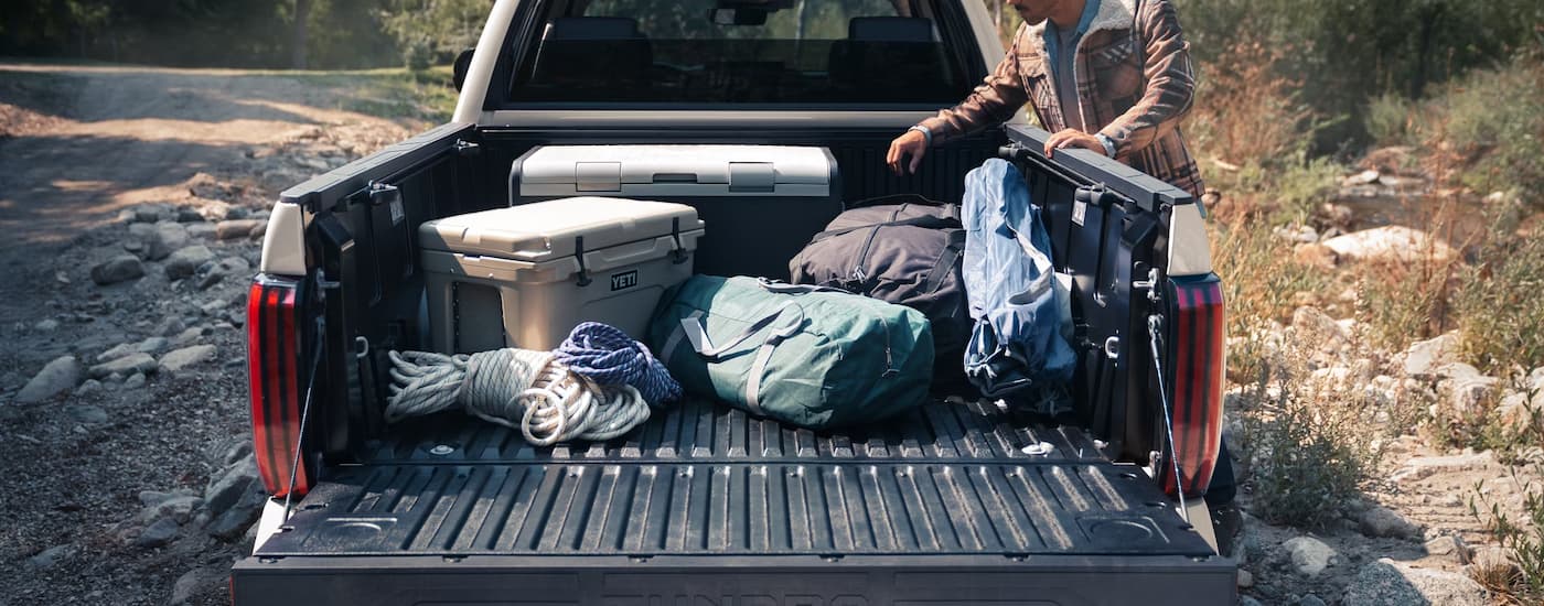 Camping gear in the bed of a white 2025 Toyota Tundra