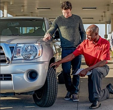 Service technician putting on a new Toyota tire.