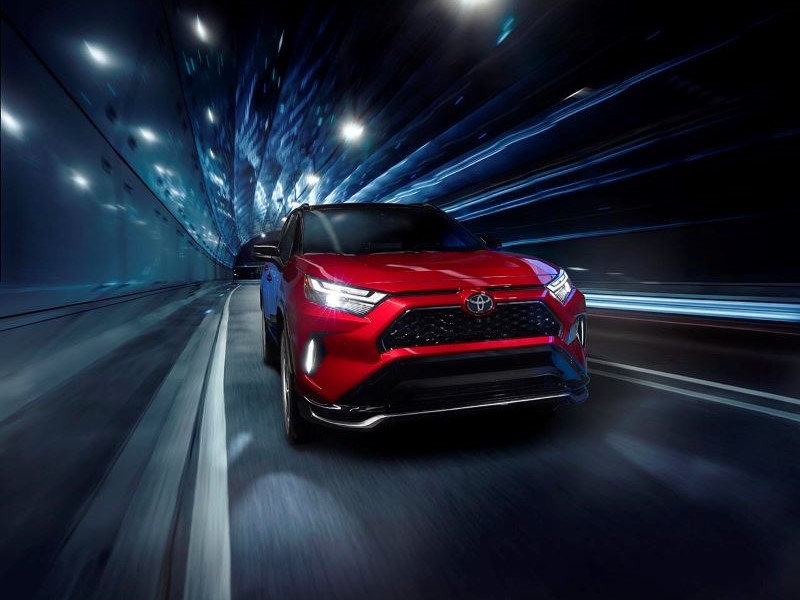 Red Toyota RAV4 Prime driving through a tunnel