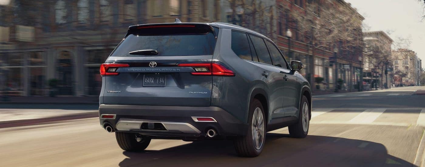 A grey 2024 Toyota Grand Highlander is shown from the rear at an angle.