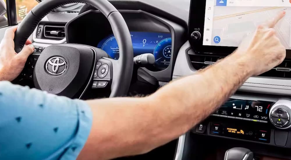 The interior of a 2023 Toyota RAV4 Limited shows the infotainment screen.
