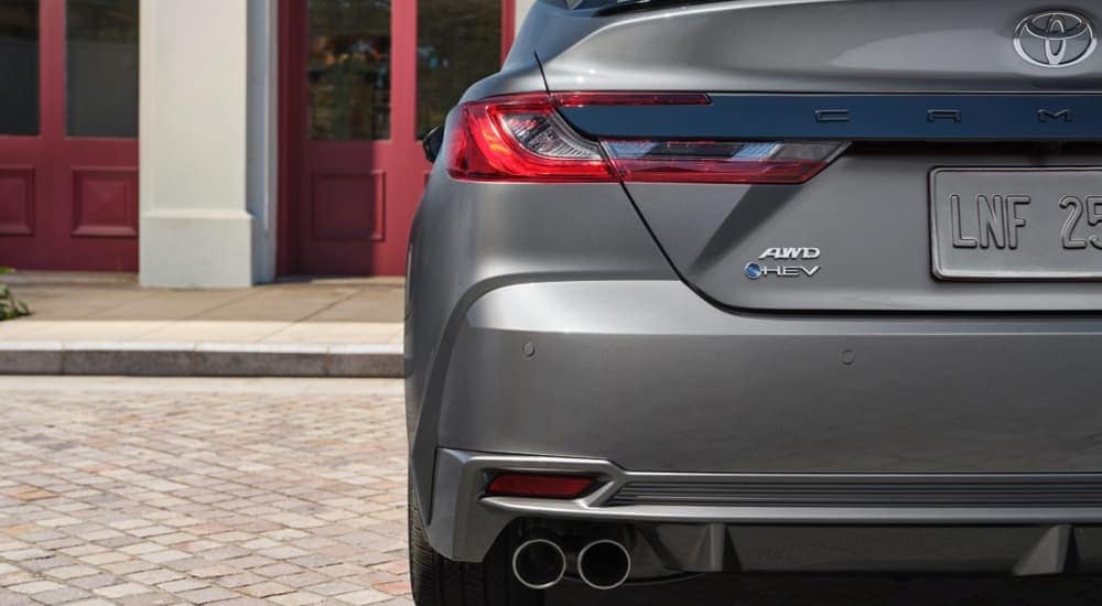 A close up of the trunk and bumper of a grey 2025 Toyota Camry HEV is shown.