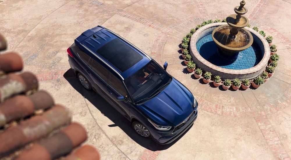 The aerial view of a blue 2024 Toyota Highlander Platinum Hybrid is shown.