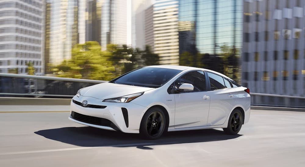 A white 2020 Toyota Prius is shown from the front at an angle.