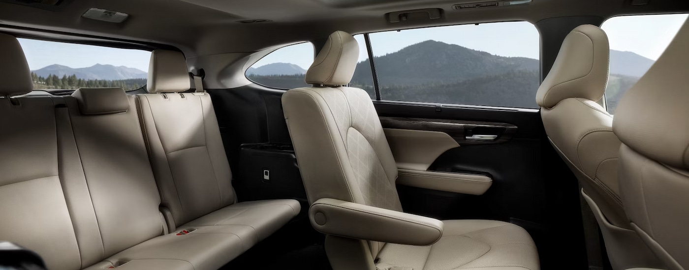 Tan upholstery and three rows of seating in a 2024 Toyota Highlander Platinum for sale in New York City.