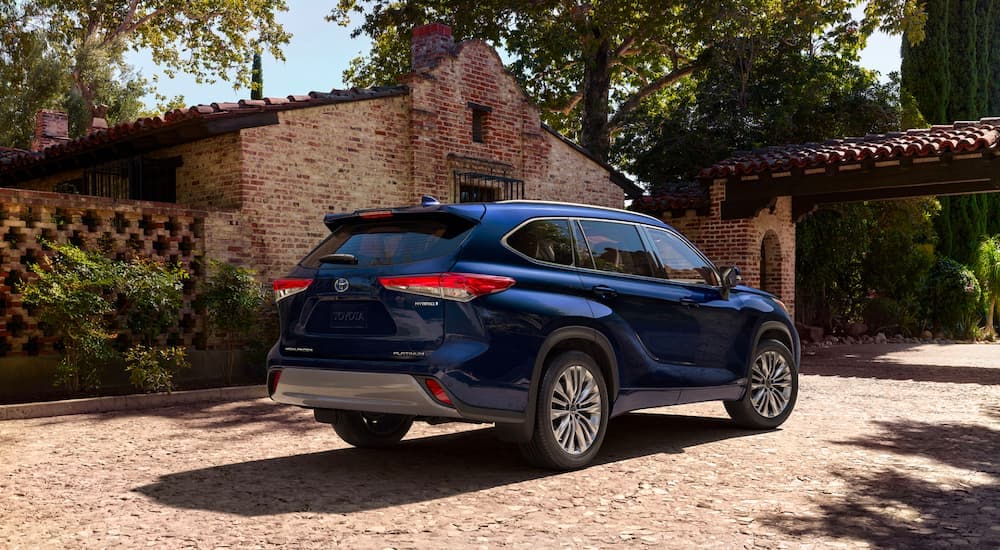a blue 2023 Toyota Highlander Platinum is shown from the rear at an angle.