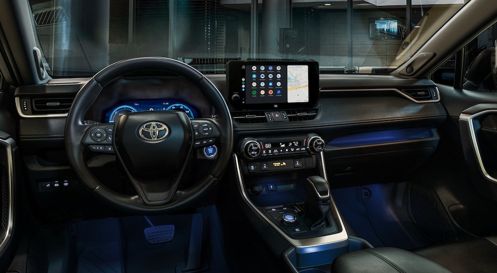 Blue ambient lighting in the cabin of a 2023 Toyota RAV4 for sale.