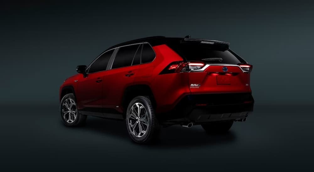2024%20Toyota%20RAV4%20Prime%20-%20Rear.jpg A red 2024 Toyota RAV4 Prime is shown parked in a dark room.