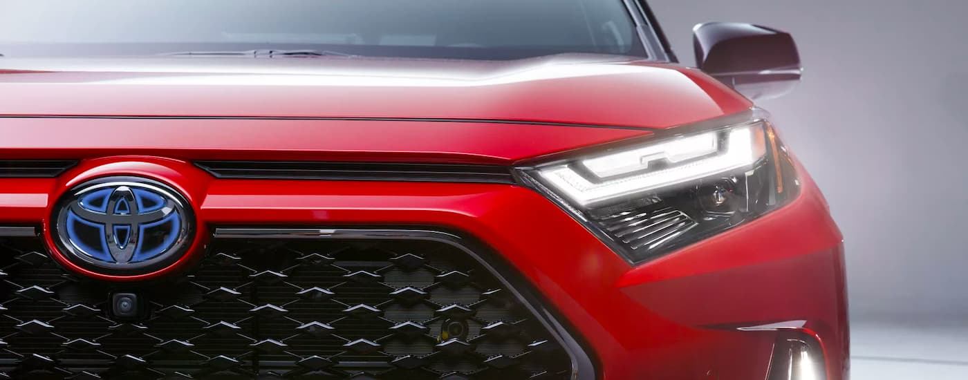 A close up of the grille on a red 2023 Toyota RAV4 Prime XSE is shown.