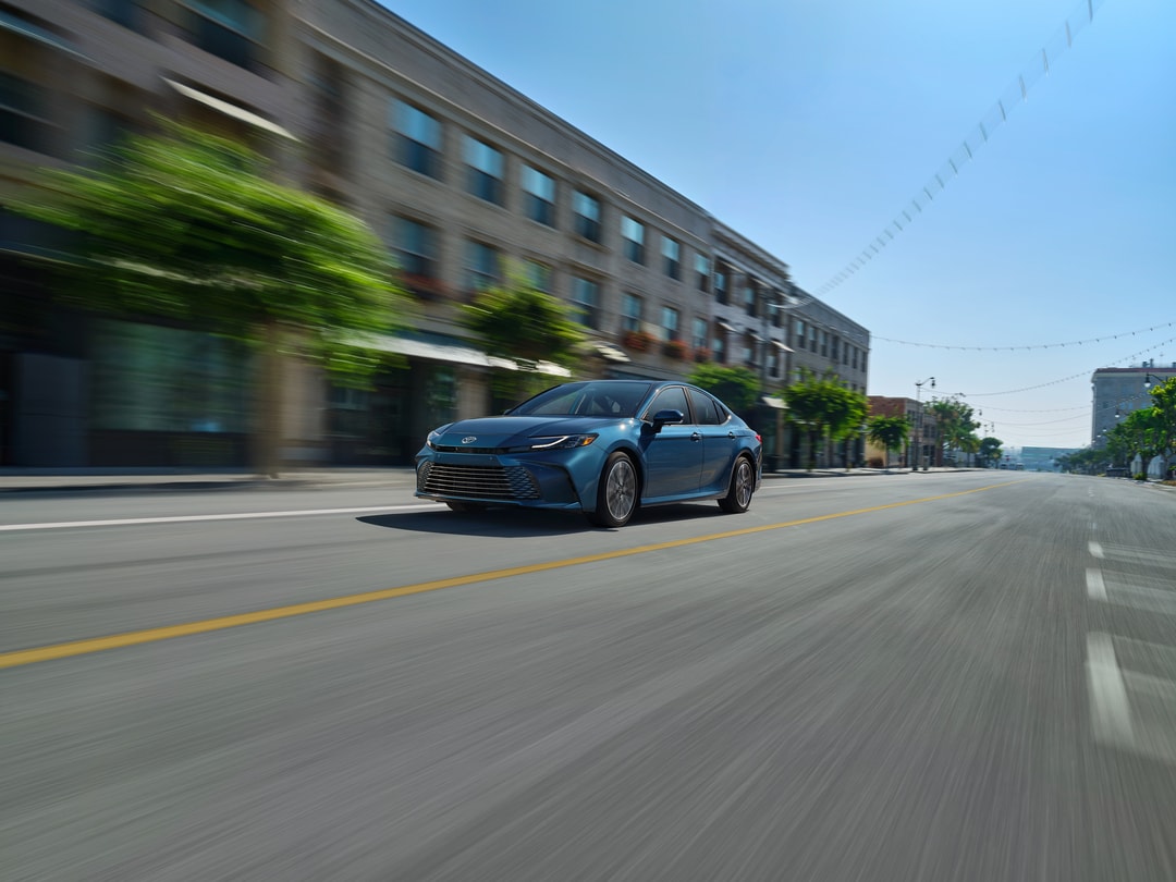 Toyota Camry driving through town