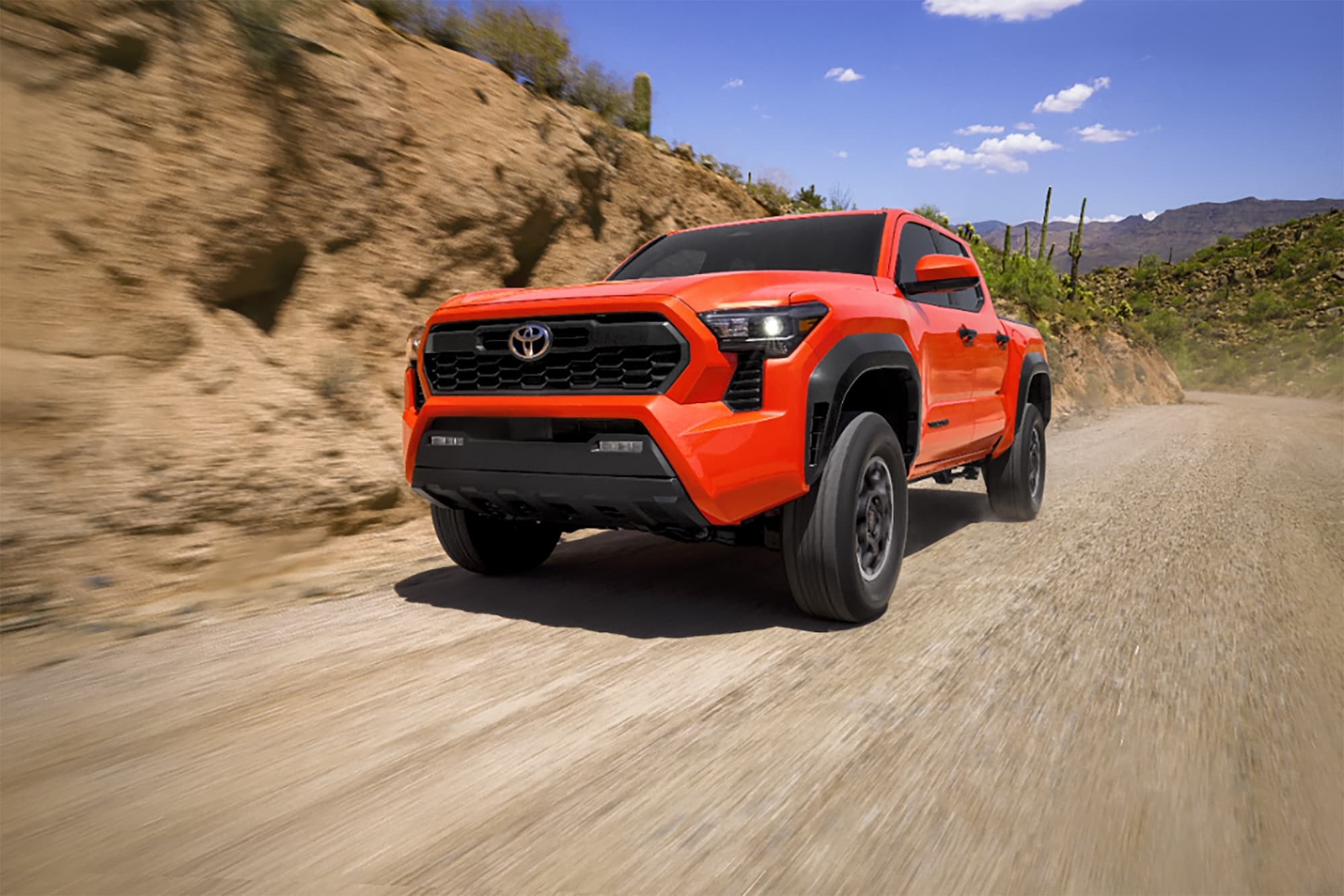  Orange 2026 Toyota Tacoma on dirt road