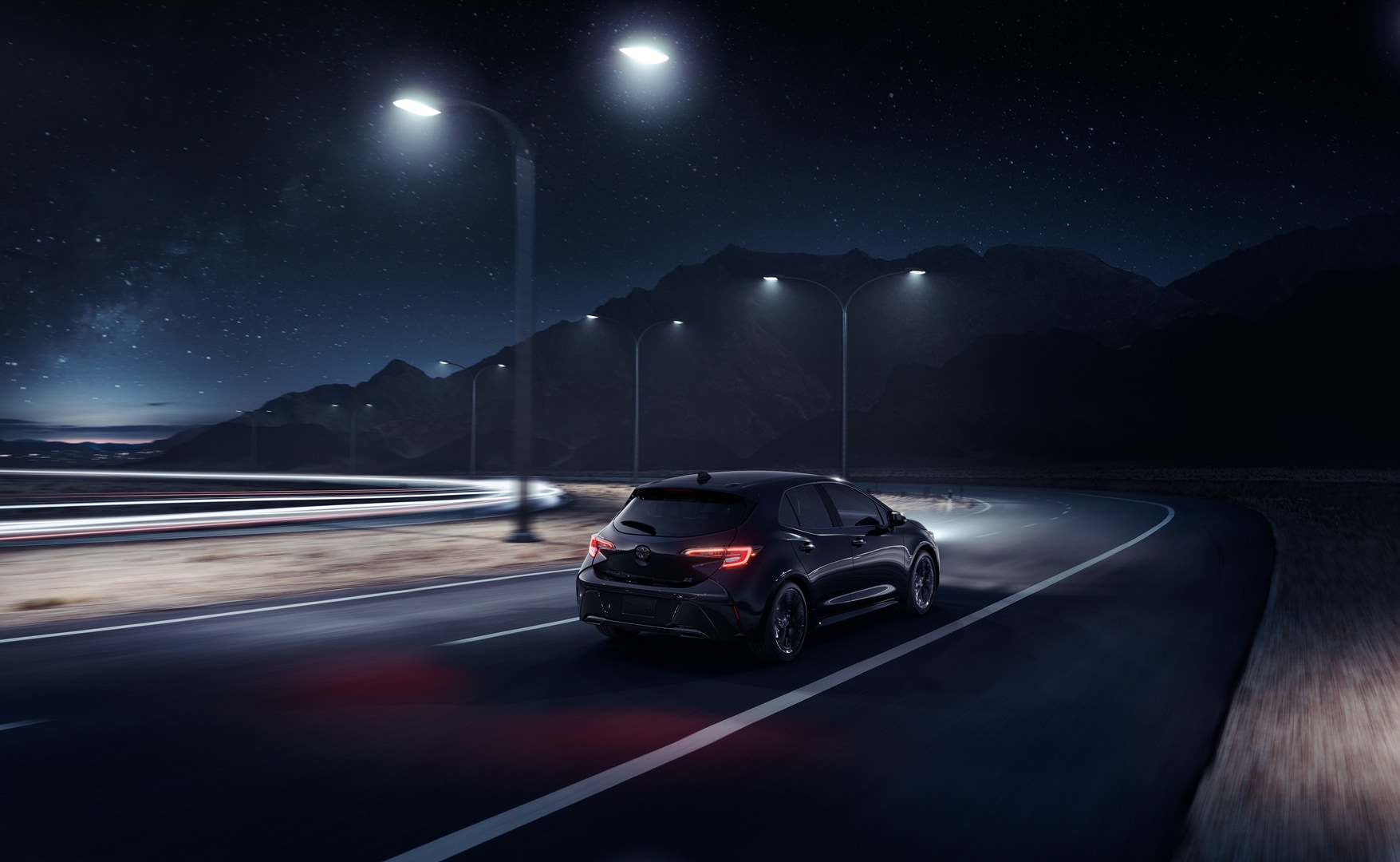 Toyota Corolla Hatchback on the road at night