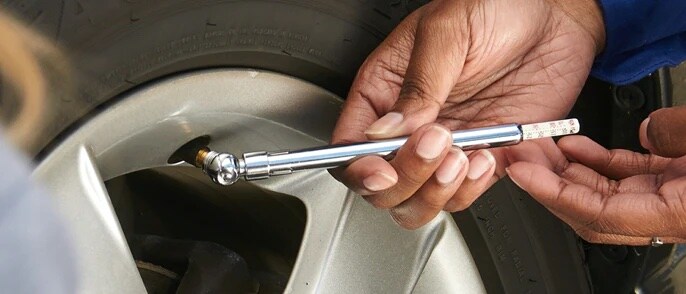 Checking tire pressure in Rockwall, TX