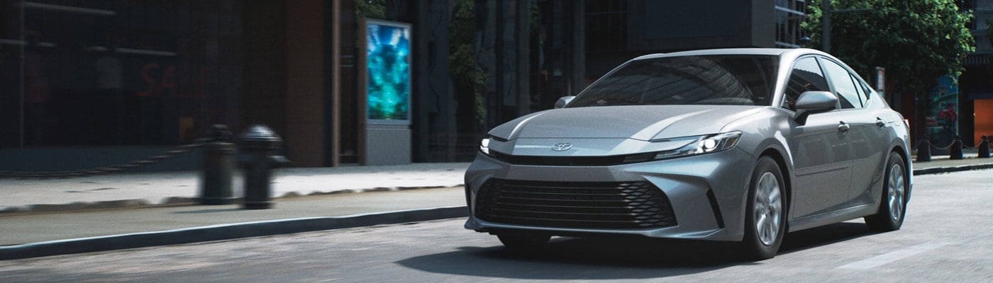 Grey Toyota Camry LE driving in a city