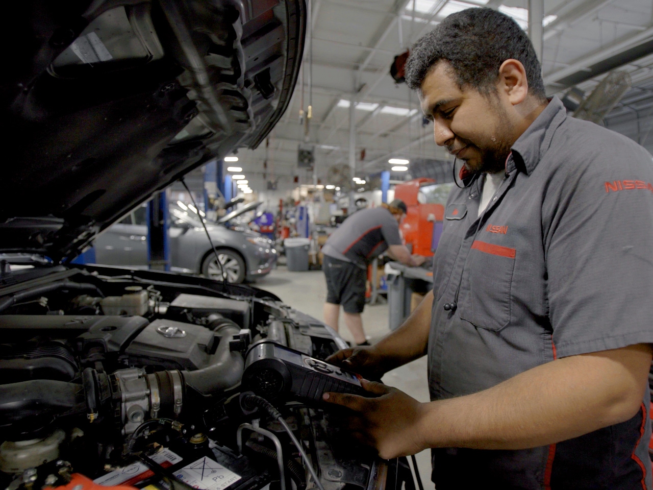 A technician diagnoses a vehicle