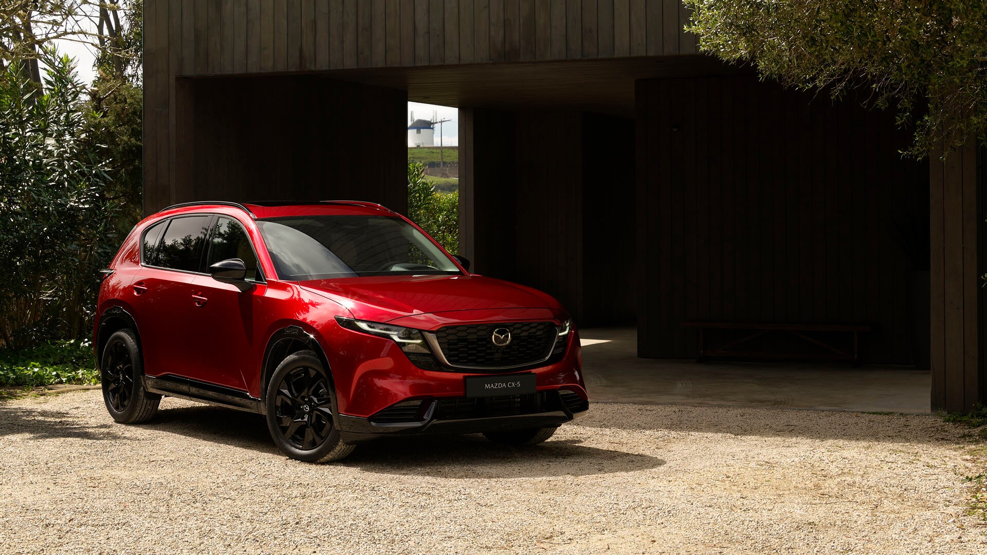The new 2026 Mazda CX-5 parked outside of the garage of a home