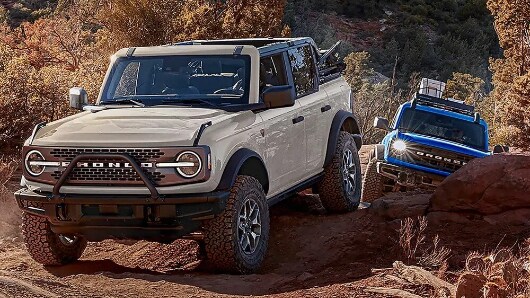 1766421052Two-2026-Ford-Bronco-SUVs-driving-off-road-530x298.jpg