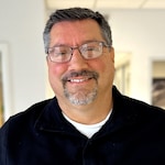 Staff member JOHN STORMS from 5d925fdad228