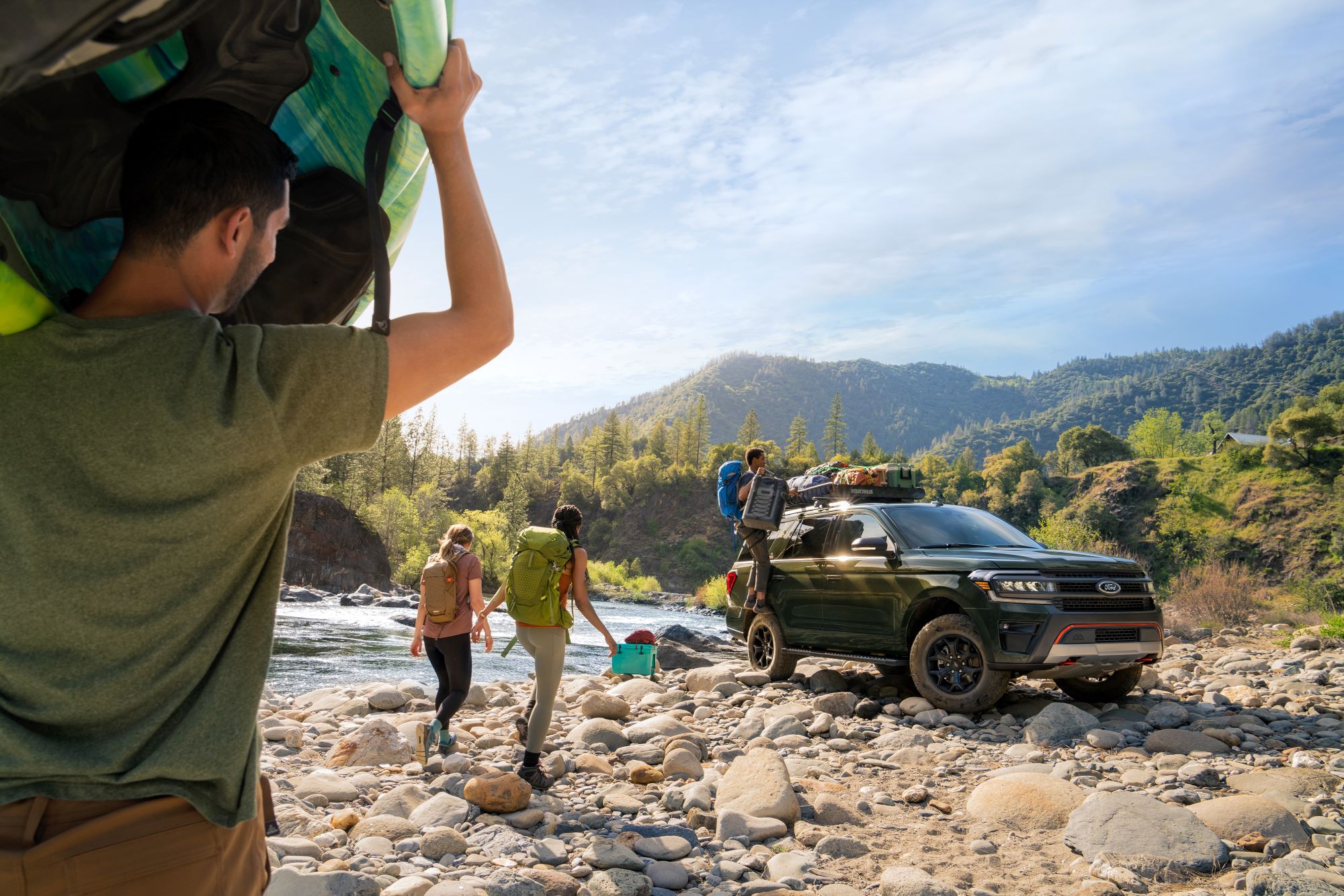 Ford Expedition on rocks by river