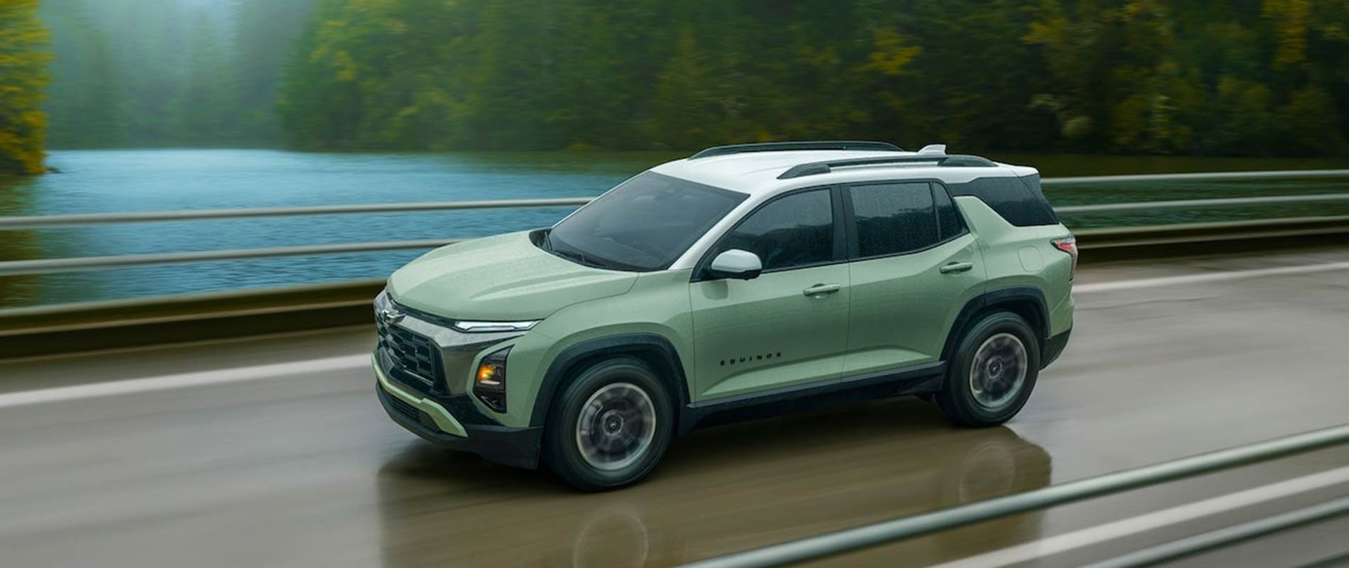 2026 Chevrolet Equinox driving on a bridge over a lake