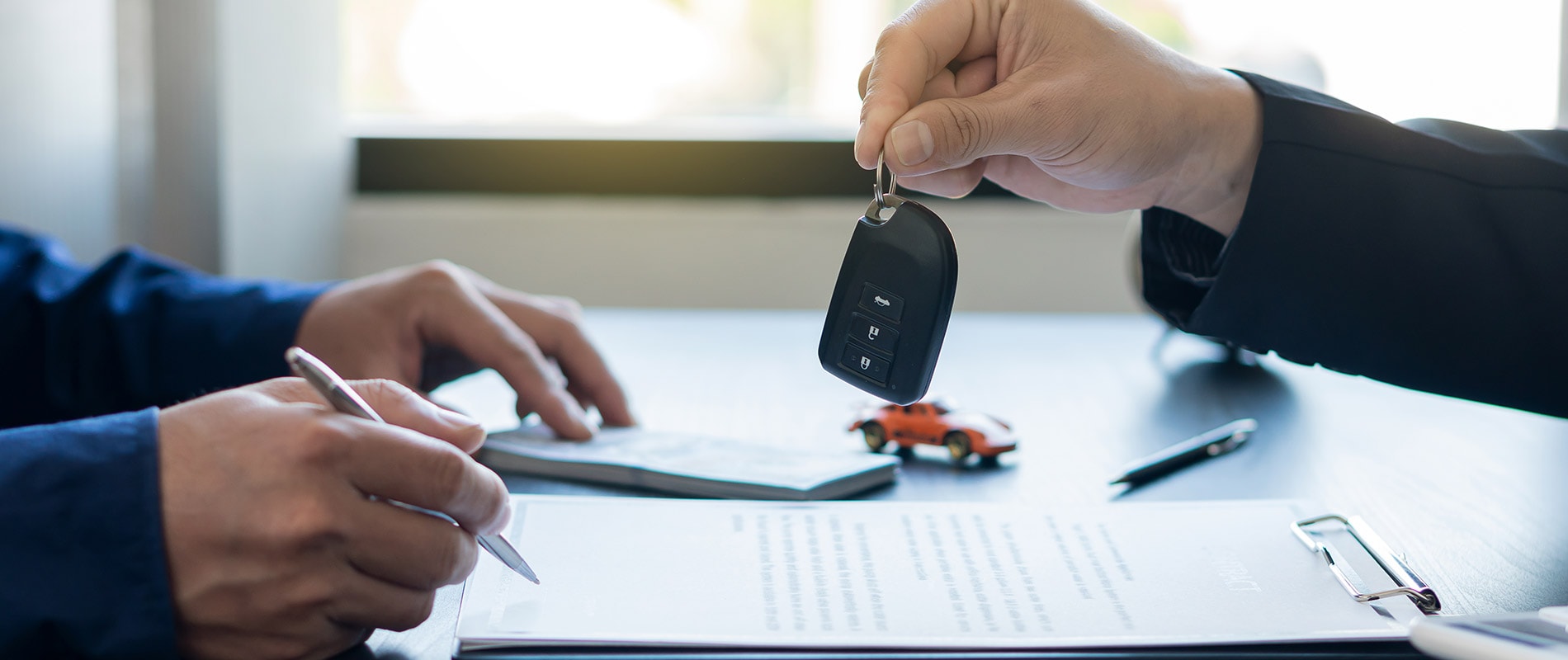 Finance professional handing a customer the keys to their Chevy