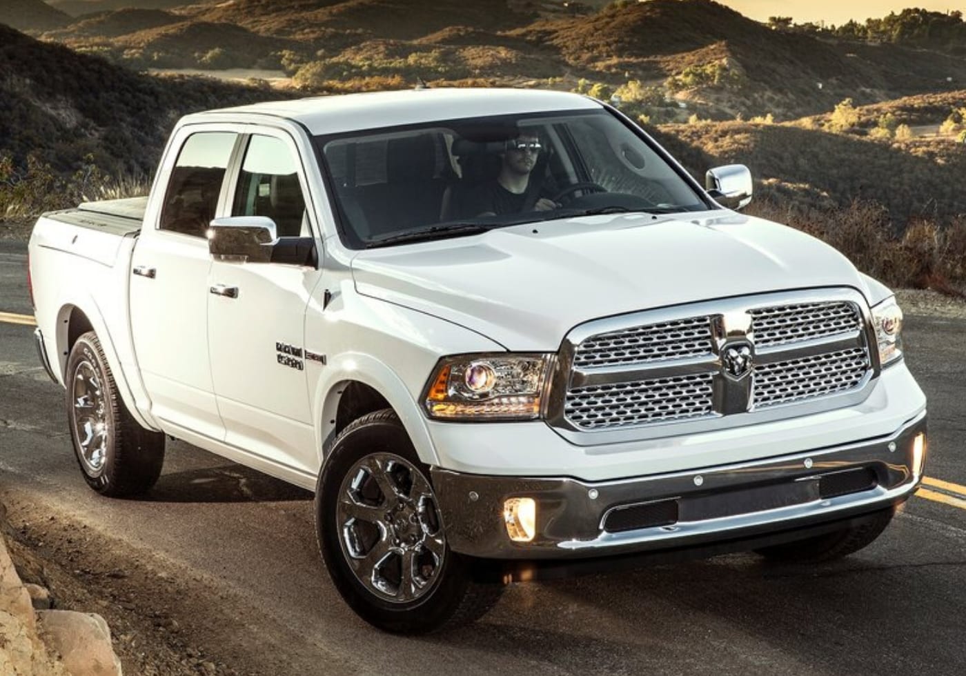 White 2014 Dodge Ram 1500 parked on a dirty road in the desert