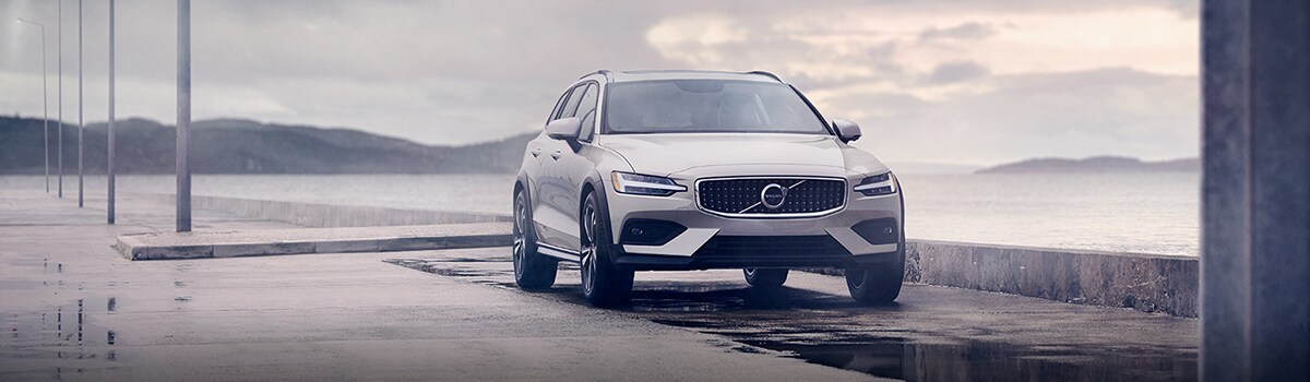 Volvo Cars New Bern is a Car Dealership near Vanceboro, NC | 2020 Volvo XC90 parked by ocean on overcast day