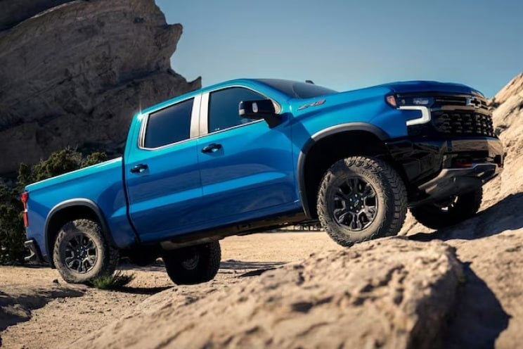 Blue Chevy Silverado off roading
