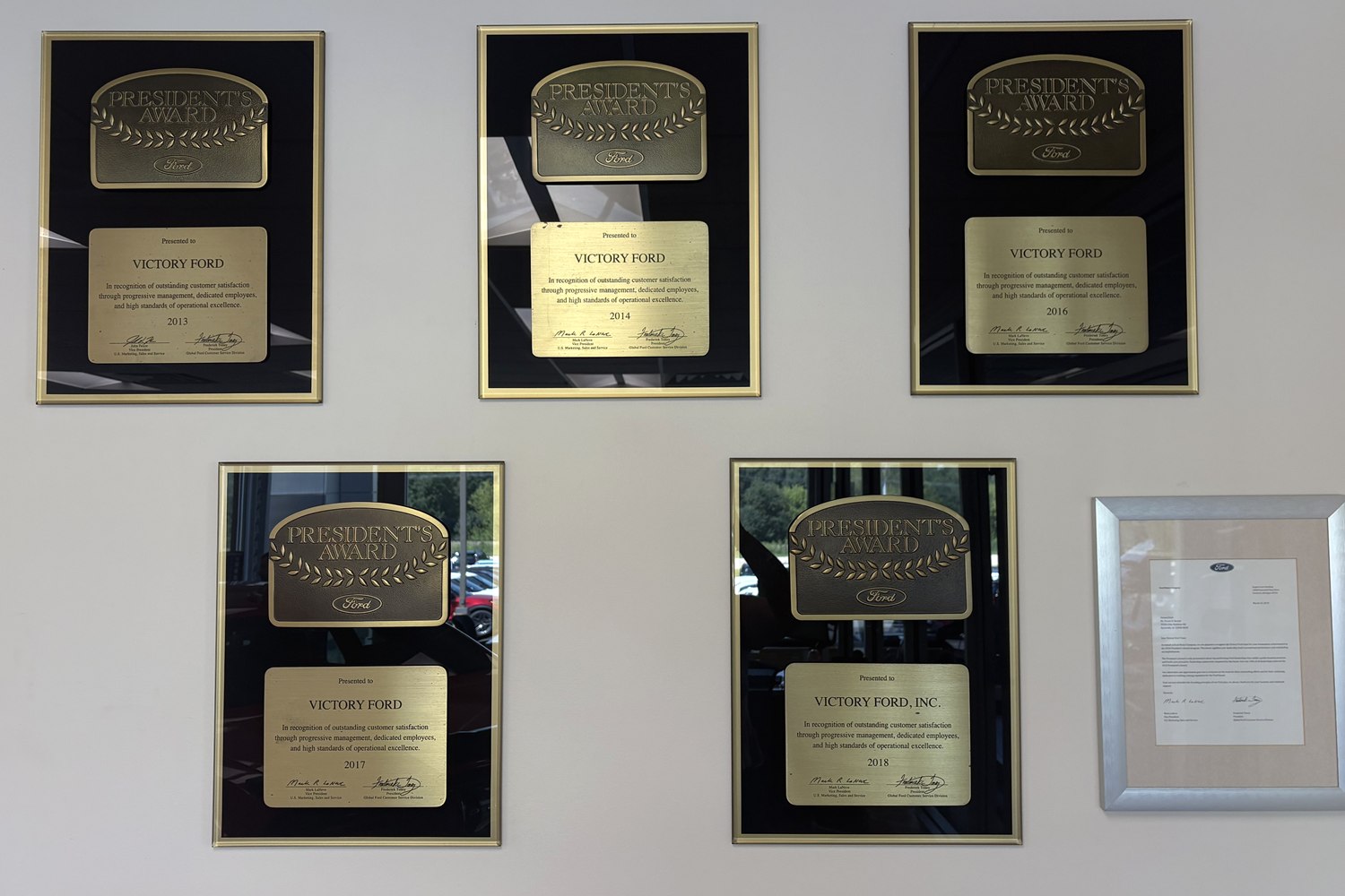 Five Ford President's Awards displayed at Victory Ford in Dyersville