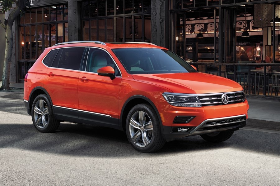 orange Volkswagen Tiguan parked in front of a cafe