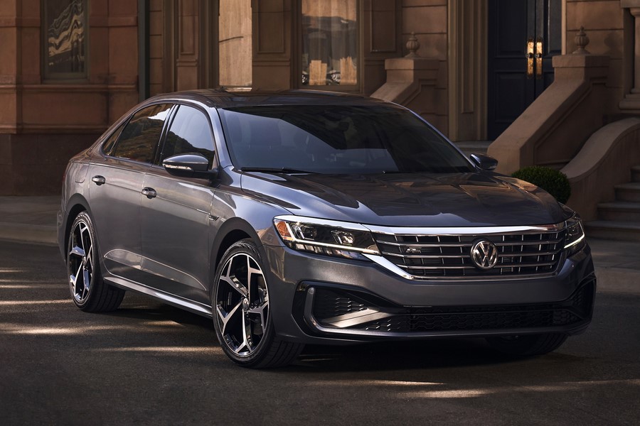 black Volkswagen Passat parked in front of townhouse stairs