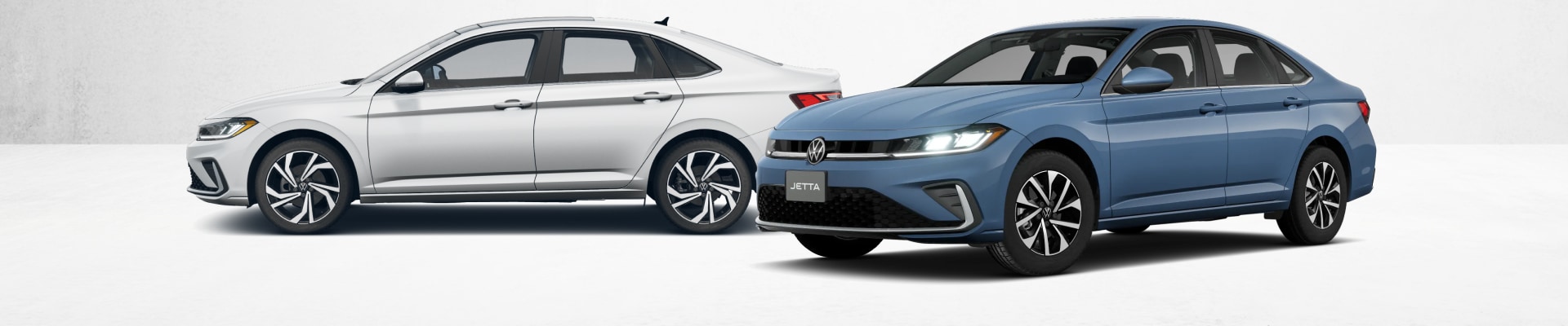 Two 2026 Volkswagen Jetta sedans parked side-by-side, one in white and one in blue