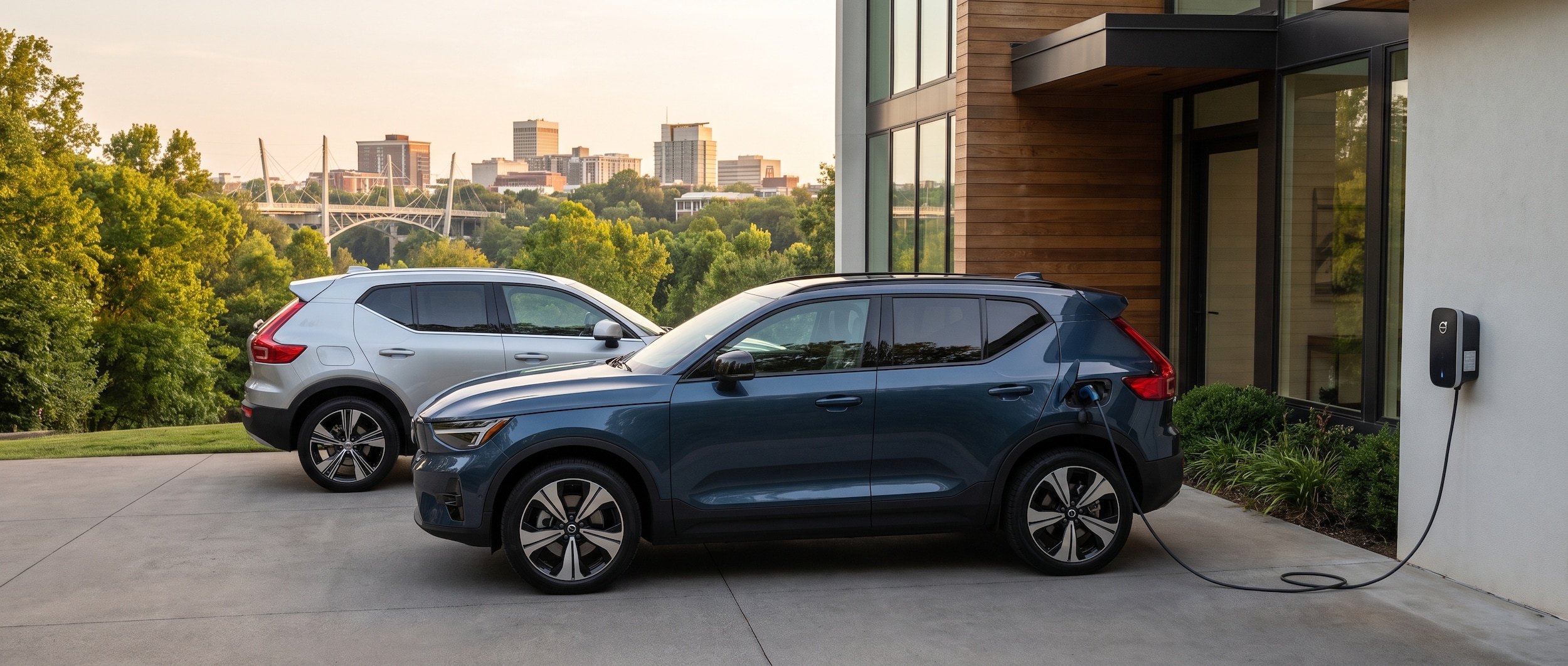 2026 Volvo EX40 charging beside a 2026 Volvo XC40 in a Greenville, SC driveway