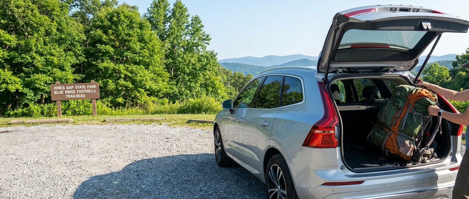 2026 Volvo XC60 with tailgate open and hiking backpacks loaded at an Upstate South Carolina trailhead