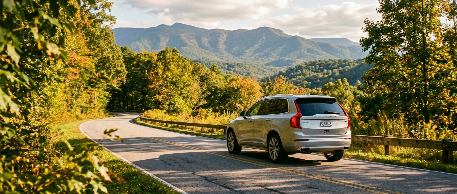 2024 Volvo XC90 certified pre-owned SUV on a scenic Upstate SC road with Blue Ridge foothills in the background