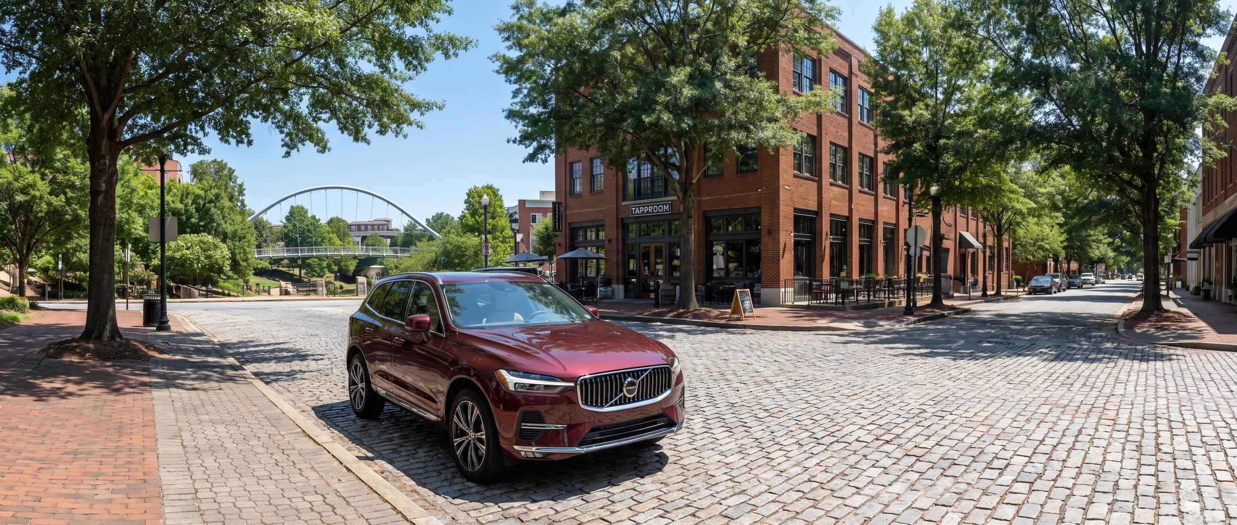 2026 Volvo XC60 parked near downtown Greenville SC brewery taproom on a summer afternoon
