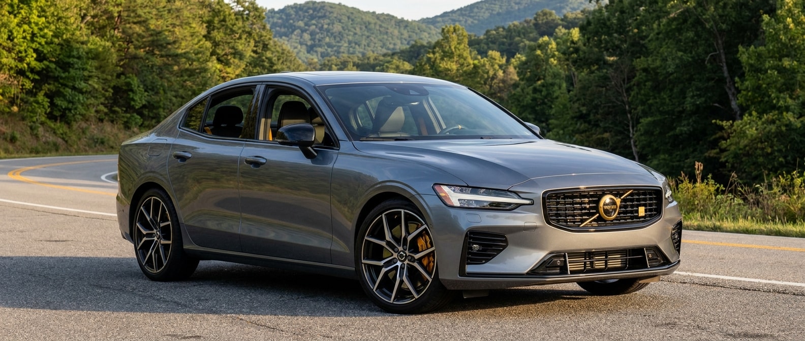 2025 Volvo S60 T8 Polestar Engineered on a winding Upstate SC road, gold Brembo calipers visible through forged alloy wheels