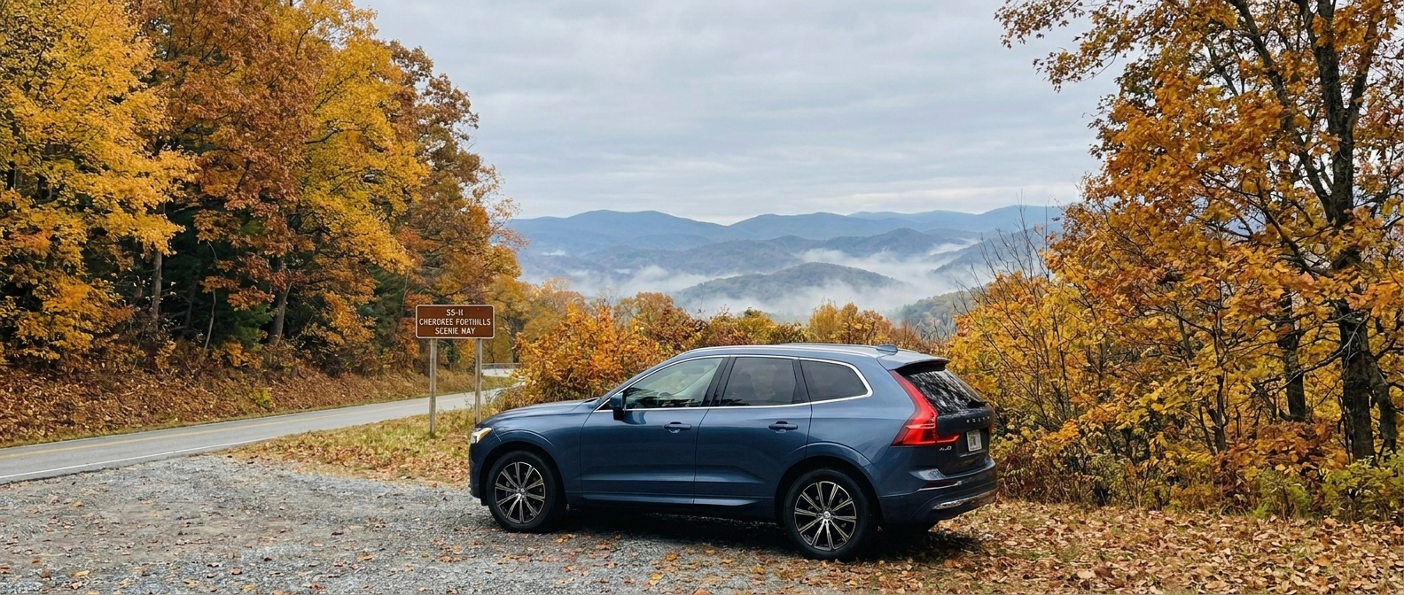 2026 Volvo XC60 on SC-11 Cherokee Foothills Highway surrounded by early autumn foliage in Upstate South Carolina