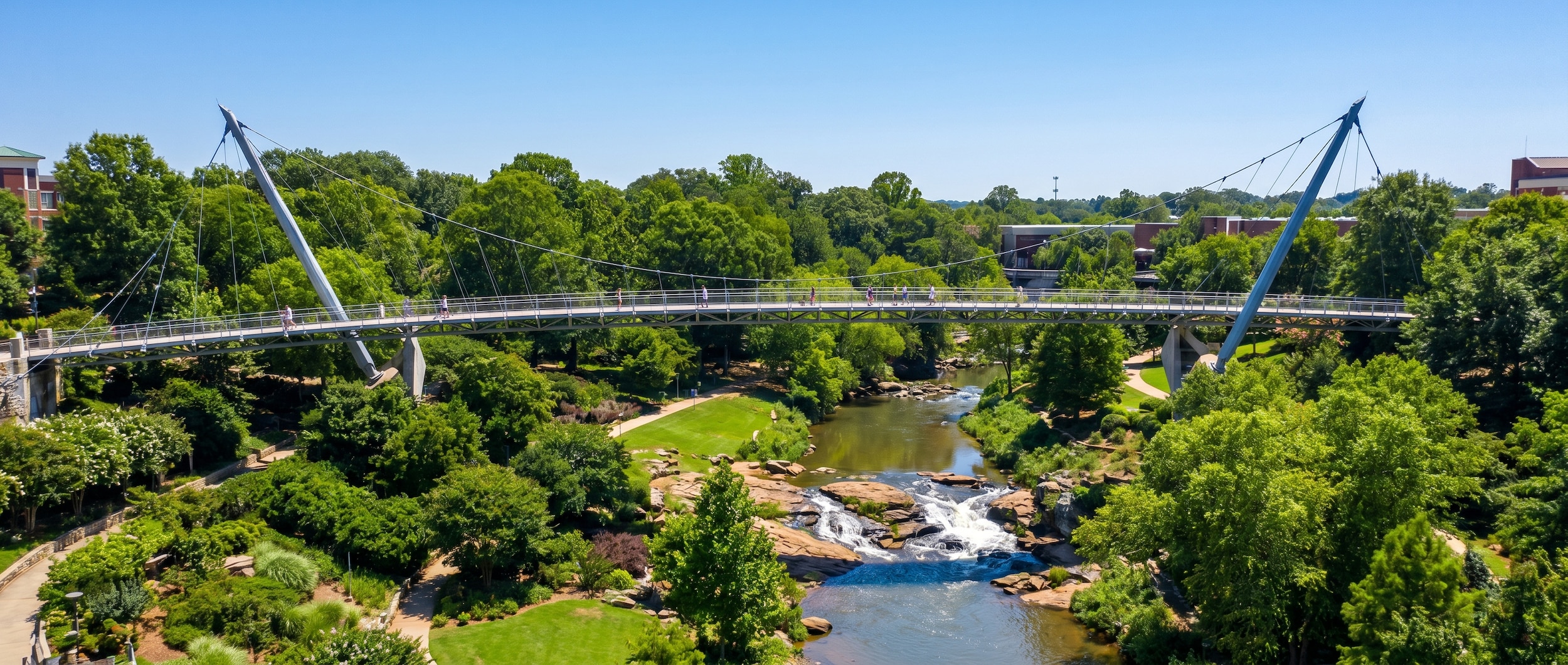 Liberty Bridge curved pedestrian suspension bridge over Falls Park in Greenville, SC