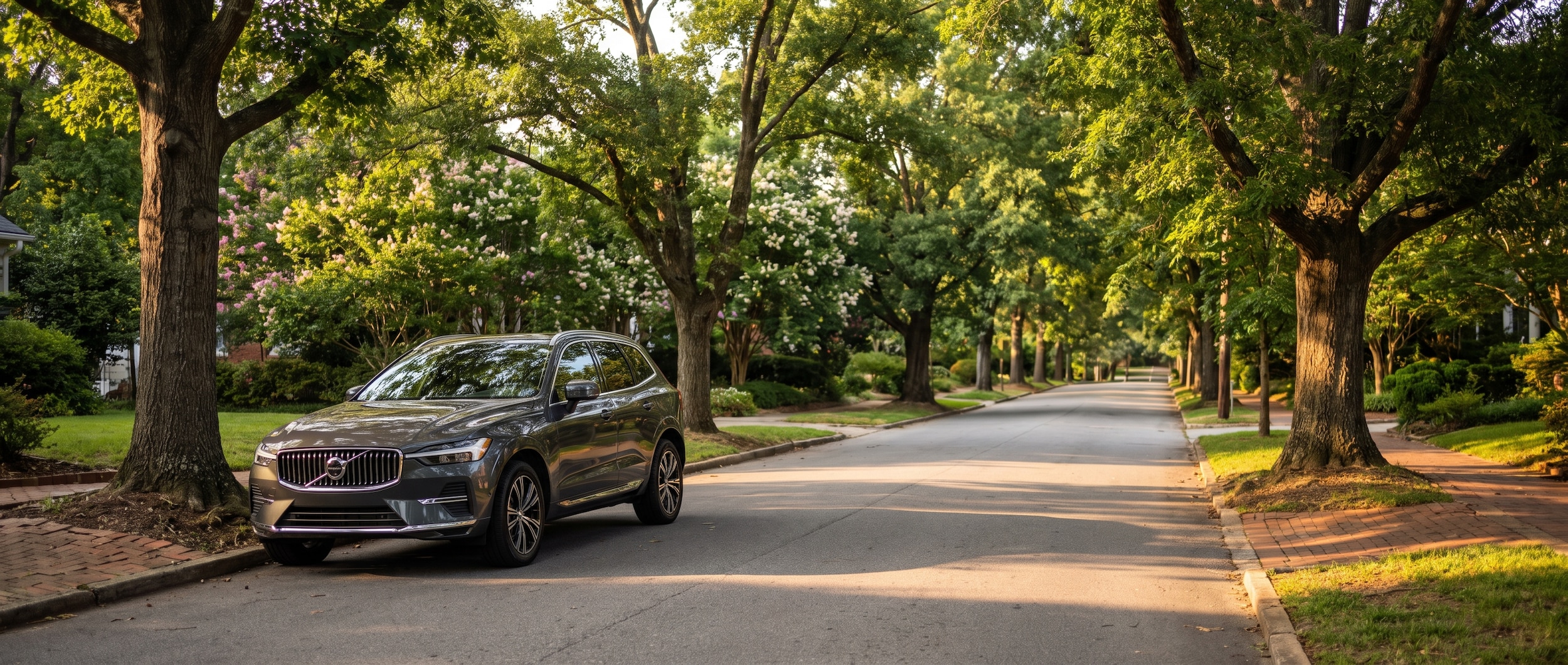 2026 Volvo XC60 parked near an ice cream shop on Laurens Road in Greenville SC on a summer evening