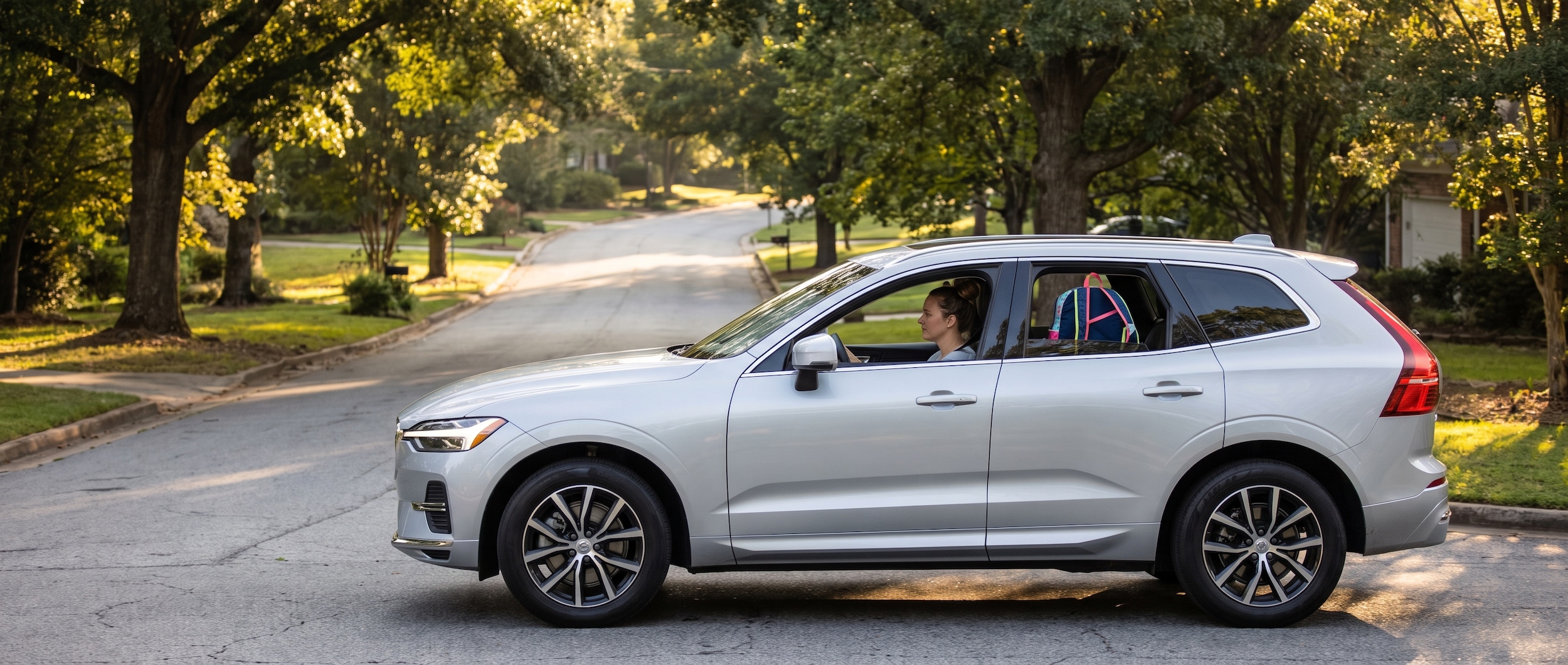 2026 Volvo XC60 navigating a Greenville SC suburban street during back-to-school morning commute