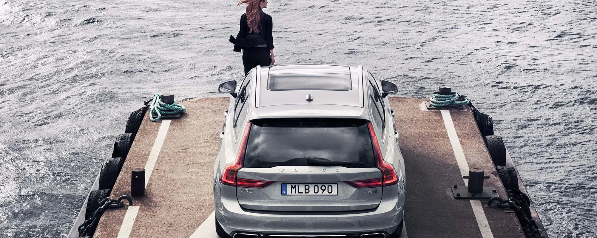 Woman waiting on Dock with her New Volvo