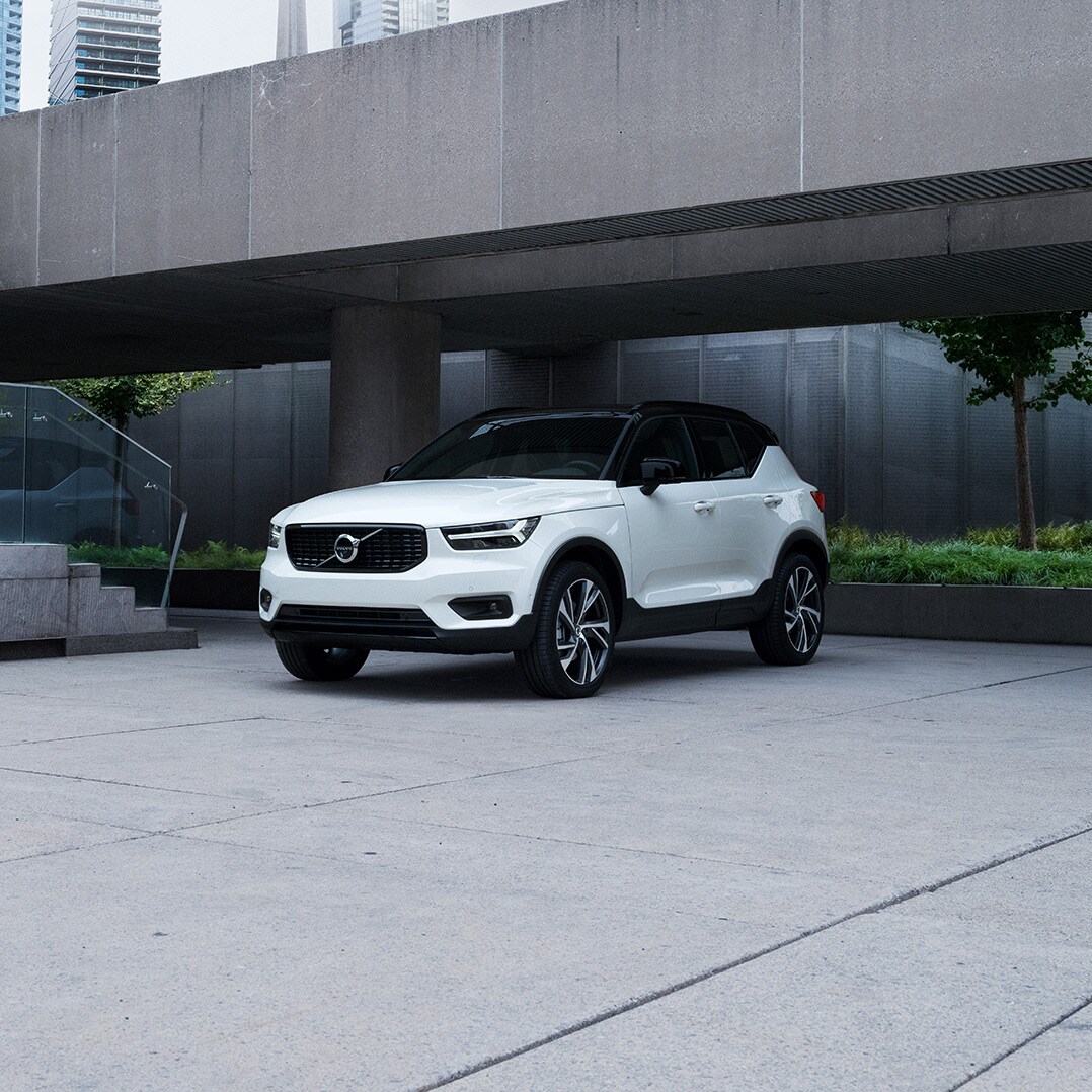 Volvo Cars New Bern is a Car Dealership near Oriental NC | White MY20 Volvo XC40 parked under concrete city bridge